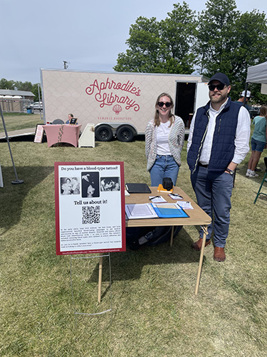 Tyler Gibb, JD, PhD, and M4 Grainne Caughey attend Black & White Days in Richmond, Utah, where they set up a table to gather stories from residents with blood-type tattoos 