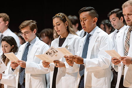 Students recite oath during White Coat Ceremony